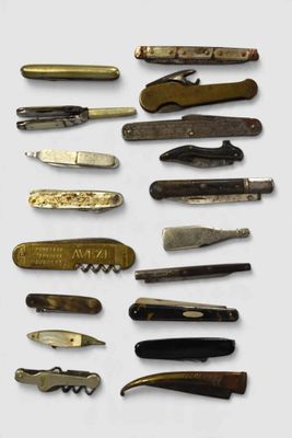many different types of pocket knives on the table