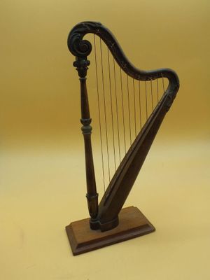 an image of a small wooden harp on a stand