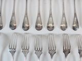 a lot of forks and spoons that are on the table