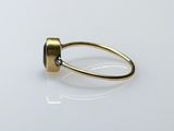a close up of a gold ring with a stone on it