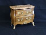 a small wooden chest of drawers on a black background