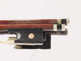 a close up of a violin bow on a white surface