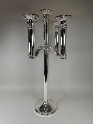a silver candelab with three candles on top of it