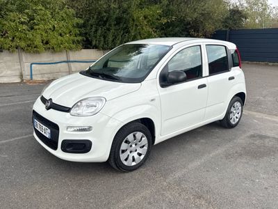 a picture of a small white car parked in a parking lot