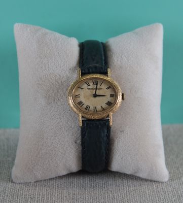 an image of a wrist watch sitting on top of a pillow