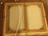 a picture of an old picture frame with a cord in it