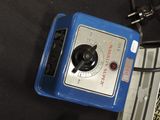 a blue radio sitting on top of a table next to a laptop computer