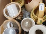 a cardboard box full of coffee cups and mugs