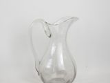 an image of a clear glass pitcher sitting on a white surface