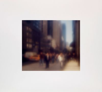 a blurry photo of people walking down a city street