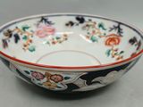 a bowl with a floral design on it sitting on a table