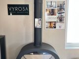 a black stove in the corner of a living room