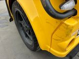 a close up of the front bumper of a yellow truck