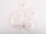 four plates and a cup on a white table