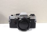 a black and silver camera sitting on a white table