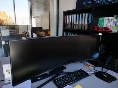 an image of a computer desk with a monitor and keyboard