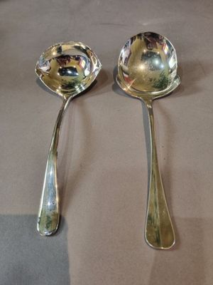 two spoons that are sitting on a table