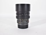 a close up of a camera lens on a white surface