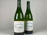 two bottles of wine sitting next to each other on a table