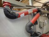 a red hose attached to the side of a machine