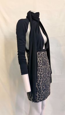 the mannequin is wearing a leopard print skirt and a black cardigan