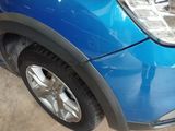 a close up of a car ' s front bumper and tire
