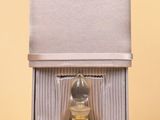 a bottle of perfume sitting in a box on a table
