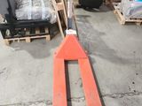 a fork lifter that is sitting in a warehouse