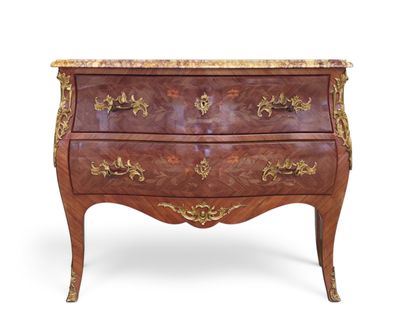 an antique chest of drawers with a marble top