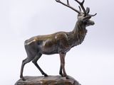 statue of a stag standing on a marble base on a white background
