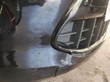 a close up of a car ' s front bumper with a hole in it
