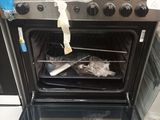 a silver oven with a bag of food inside of it