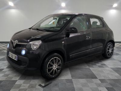 a picture of a small black car parked on a checkered floor