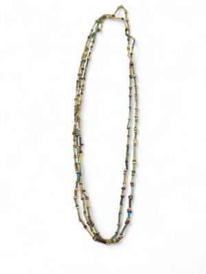 a close up of a necklace with beads on a white background