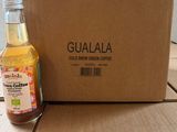 a bottle of gulala next to a box of coffee