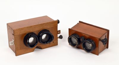 two wooden cameras sitting next to each other on a white surface