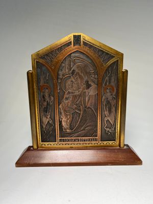 an image of a metal plaque with a picture of a man and a woman on it
