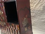 a small wooden cabinet with a mirror on top of it
