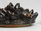 a black plate with a bunch of black birds on it