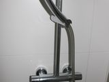 a close up of a shower head with a hand held shower head