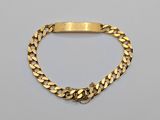 a gold bracelet with a curb link