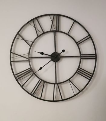 a large clock that is on the wall in the room