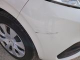 a close up of a white car with scratches on it