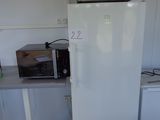 a white refrigerator and a microwave in a small kitchen