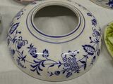 a blue and white vase sitting on a white table