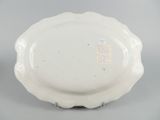 an image of a white plate on a table with a tag on it