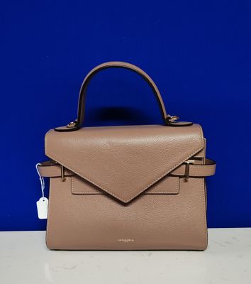 un sac à main en cuir beige orné d'une petite pochette sur le devant