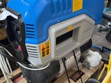 a blue and white machine that is on a pallet