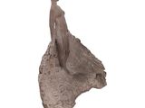 statue of a woman standing on a rock with a white background
