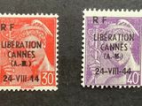 four different colored postage stamps on a black surface